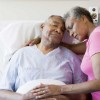 older couple embrace in hospital room