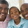 grandfather, father, and grandson smile for camera