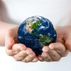young hands hold model of earth