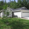 Figure 1. A young tree planted in front of a new home in Gainesville, FL, that in the future will store and sequester carbon and reduce carbon emissions by shading the home.