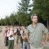 Teacher with students on road in forest