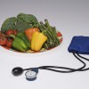 Plate of vegetables and a blood pressure cuff and monitor