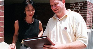 Theresa Ferrari, left, extension youth development specialist in the Department of Family, Youth and Community Sciences, and Steve Jacob review findings form the citizen survey.