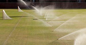 Sprinklers watering athletic fields.