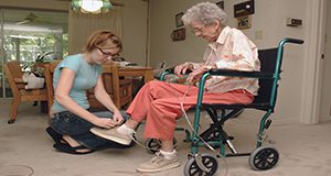 Elderly person receiving assistance from a caregiver with everyday tasks. UF/IFAS Marisol Amador