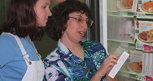 University of Florida Associate Professor Linda Bobroff shows a student how to read a nutrition label on a frozen dinner, Tuesday (10/14), as part of Smart Food Shopping for Teens, a program developed at UF's Institute of Food and Agricultural Sciences. The program also teaches teens about enviroshopping, the practice of choosing products that are not overpackaged and that can be recycled. The program is aimed at teaching teens good shopping and eating habits before they form bad ones.