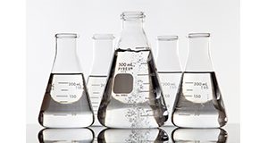 Beakers and flasks of clear fluid. Ethanol, biofuel, chemistry, science, liquid
