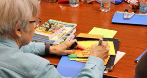 A participant fills out a data card during a journey-mapping session.