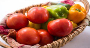Basket of fresh tomatoes and bell peppers. UF/IFAS file photo.